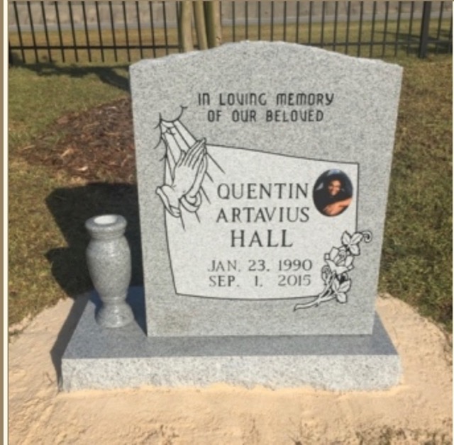 Standing headstone with carvings and photo. Vase attached