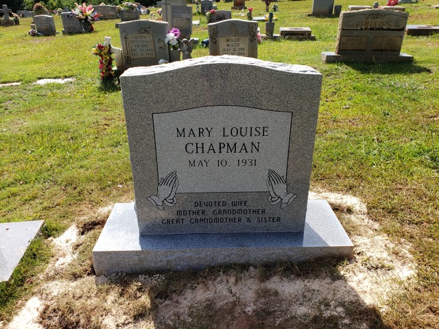 Standing headstone with carving of praying hands